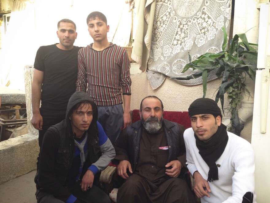 Mahmoud Jaser was hit with shrapnel in the July 2014 attack. In this April photo he is surrounded by four of his sons: clockwise from upper left, Adham, Odai, Abdel Razik and Saqir.
