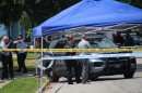 Police officers look at the car of North Kansas City Police Officer Daniel Vasquez, who was fatally shot during a traffic stop on July 19, 2022.