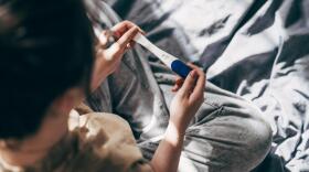 A woman takes a pregnancy test at home. (Viktoriya Skorikova/Getty Images)