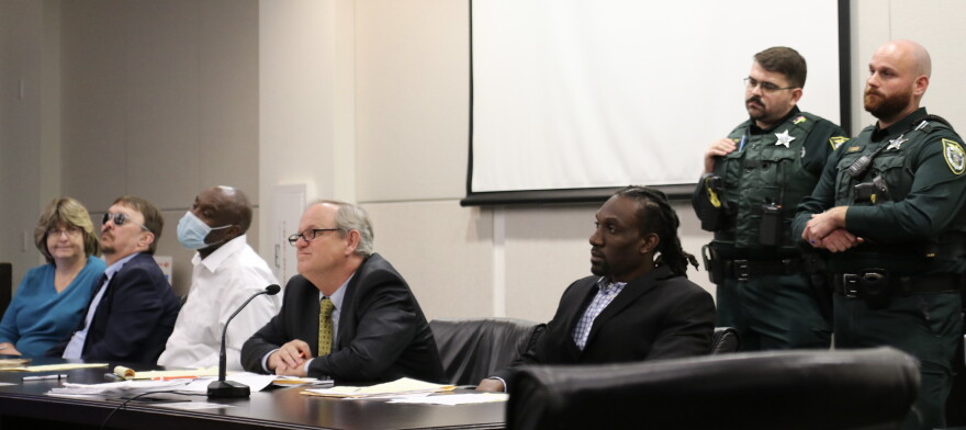 Keneth Altidor (third from left) and Nikenson Perin (right), sitting with their attorneys, look at autopsy images of Christin Cassels' injuries. According to District 8 chief medical examiner, Milad Webb, the gunshot wound to Cassels' head killed her instantly. (Katie Klaiber/WUFT News)