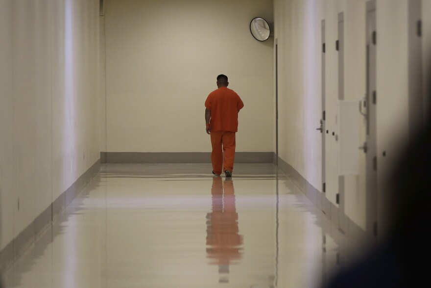 A detainee walks in a hallway during a media tour at the U.S. Immigration and Customs Enforcement detention facility in Tacoma on Sept. 10, 2019.