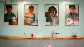pictures of kids scooping ice cream on a wall in an ice cream shop