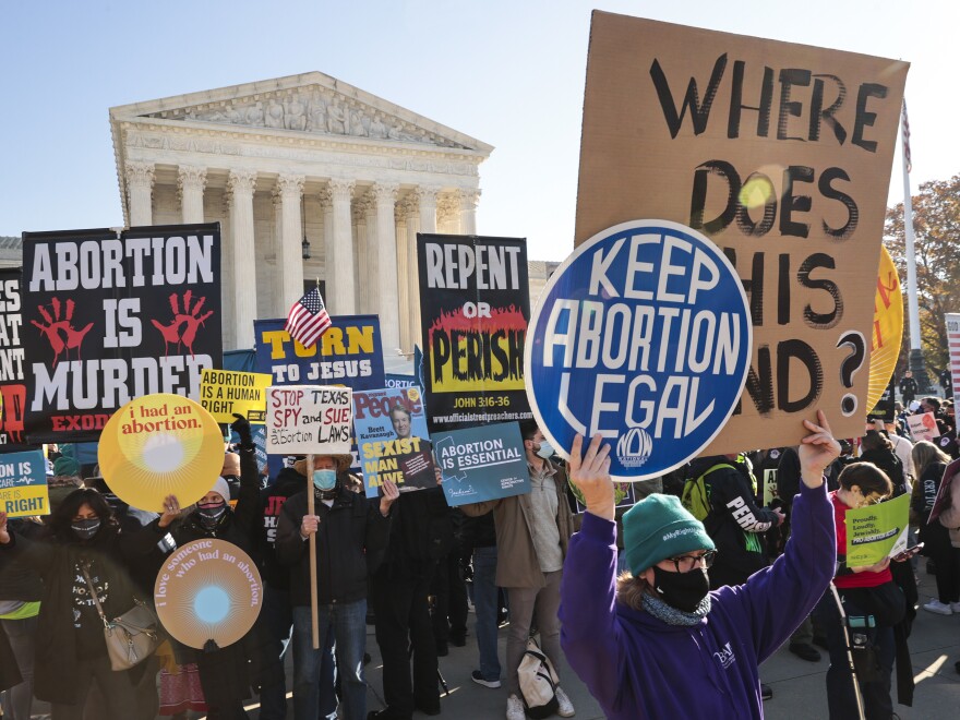 Demonstrators gather in front of the Supreme Court as the justices hear arguments earlier this month in Dobbs v. Jackson Women's Health, a case about a Mississippi law that bans most abortions after 15 weeks.