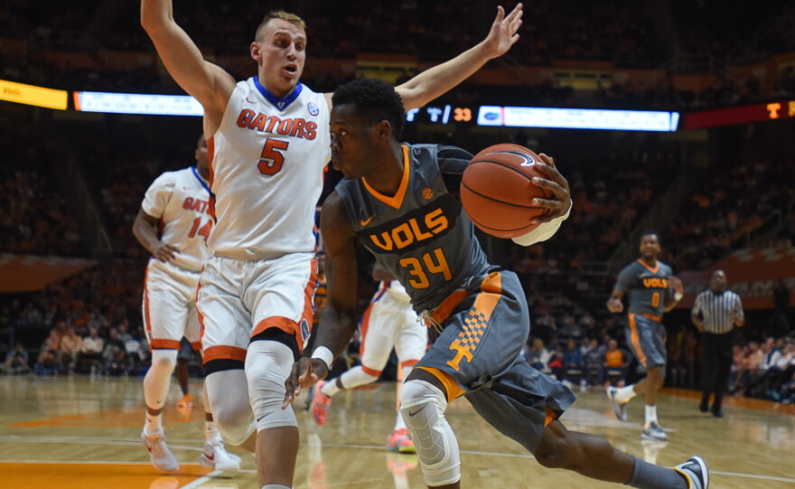 Tennessee's Devon Baulkman (34) drives on the baseline while being defended by Florida's Alex Murhpy (5) in the second half. (Greenberry Taylor/WUFT News)