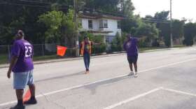 Gordon Smith and his crew flag down passing cars to park in his grass lot along South Street. Photo: Brendan Byrne