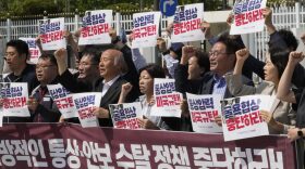 South Korean protesters stage a rally against U.S. President Donald Trump's tariffs policy outside the Government Complex in Seoul, South Korea, Wednesday, May 14, 2025. The letters read "We condemn the U.S. for pressuring trade negotiations." (AP Photo/Ahn Young-joon)
