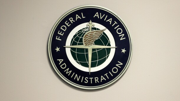 FILE - A Federal Aviation Administration sign hangs in the tower at John F. Kennedy International Airport in New York, March 16, 2017. (AP Photo/Seth Wenig, File)