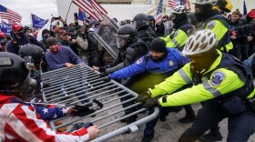 In this Jan. 6, 2021, file photo, Trump supporters try to break through a police barrier at the Capitol in Washington.