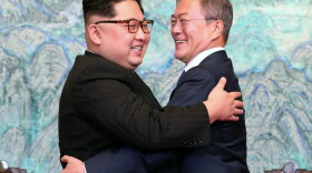 North Korea's leader Kim Jong Un (left) and South Korea's President Moon Jae-in (right) hug during a signing ceremony near the end of their historic summit at the truce village of Panmunjom on April 27, 2018. (Korea Summit Press Pool/AFP/Getty Images)