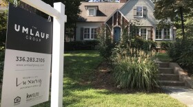 For Sale sign in front of a home