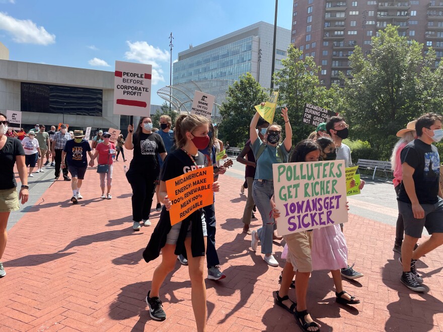 The protesters met outside before walking into MidAmerican Energy's headquarters in downtown Des Moines on Wednesday.