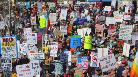 large crowd of people with protest signs
