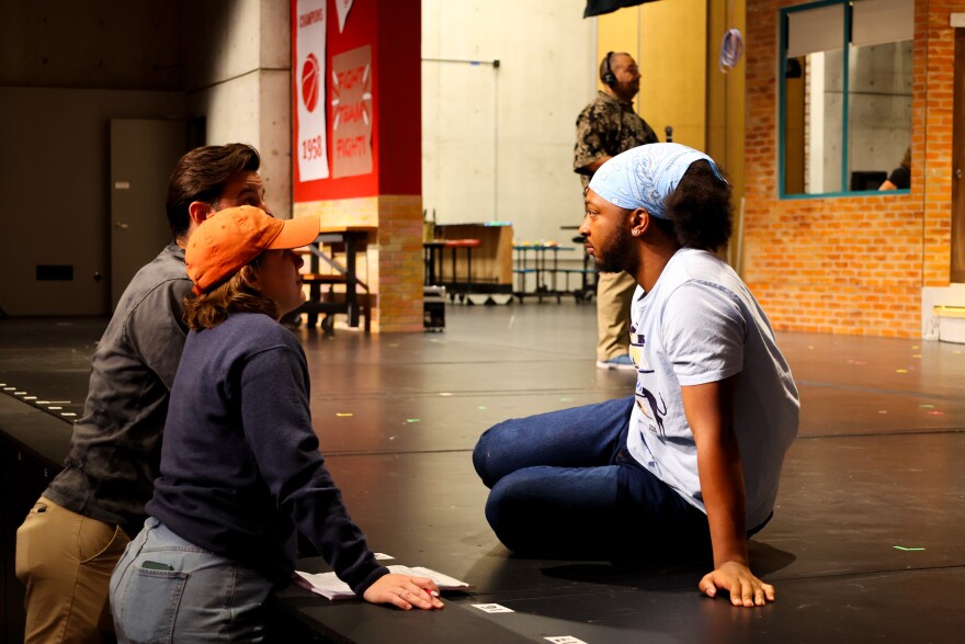 Co-choreographers and co-directors Capri Williams and Eric Smead discuss a scene with an actor during rehearsals.