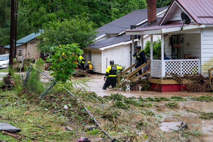 Rescuers travel door to door checking with residents during flooding in Dante that started July 18 and lasted through the weekend