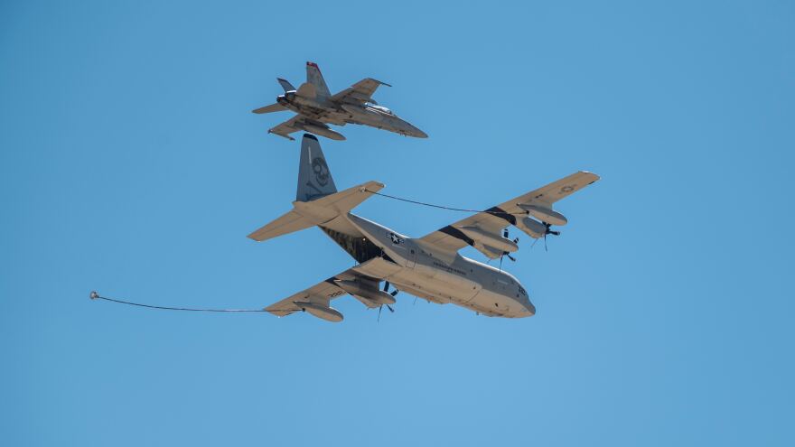 Two military planes during a mid-air refueling.