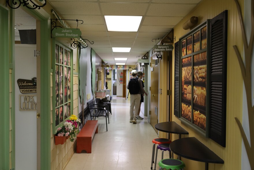 Two students walk down the PEAK Christian Academy classroom hallway. Photo by Baylie Simon.