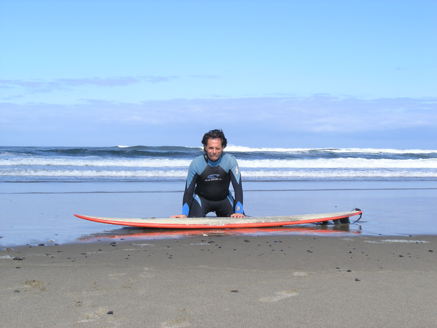 Man and surfboard on the beach