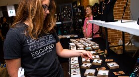 A visitor shops for jewelry at the craft sale