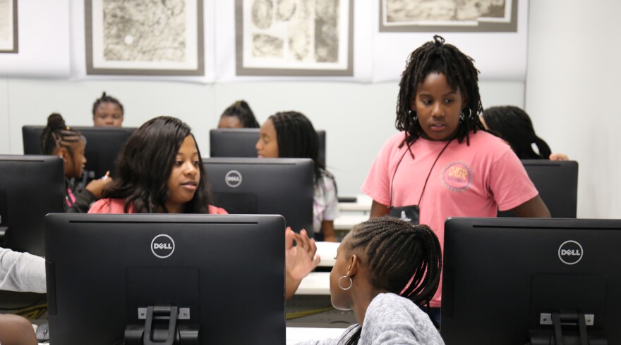 Instructor Jaya Gantt, a recent graduate of USC, teaches 6th-grader Kenney Williams and other students at Girls Go for I.T. camp.