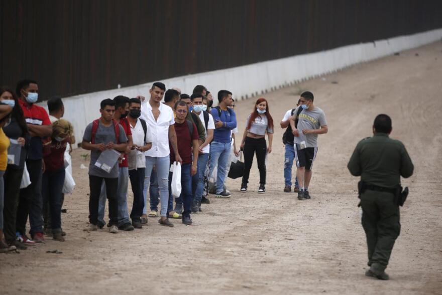  A Border Patrol agent instructs migrants who had crossed the Rio Grande river into the United States in Eagle Pass, Texas, Friday, May 20, 2022. The Eagle Pass area has become increasingly a popular crossing corridor for migrants, especially those from outside Mexico and Central America, under Title 42 authority, which expels migrants without a chance to seek asylum on grounds of preventing the spread of COVID-19.