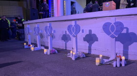 Five white crosses honoring the lives of those killed at Waukesha's annual Christmas parade were surrounded by flowers and candles.