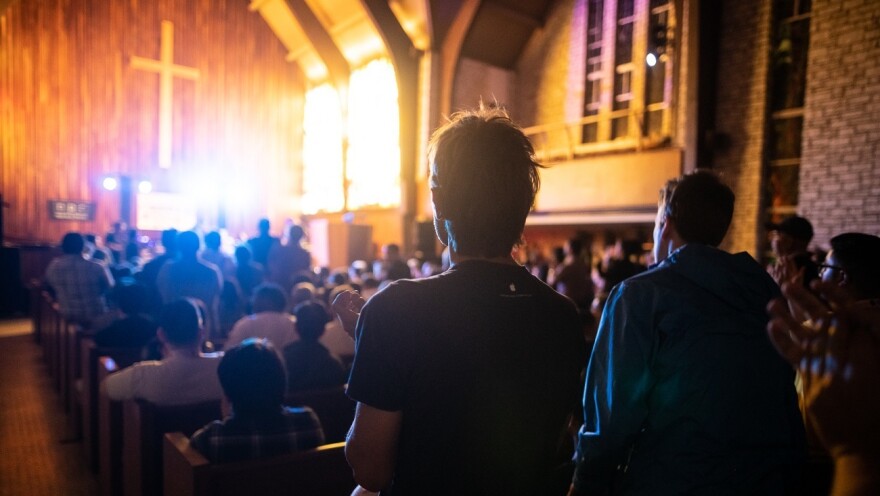 Onlookers watch Gaelynn Lea's performance at the Tiny Desk Family Hour at Central Presbyterian Church in Austin, TX, during the 2019 SXSW music festival.