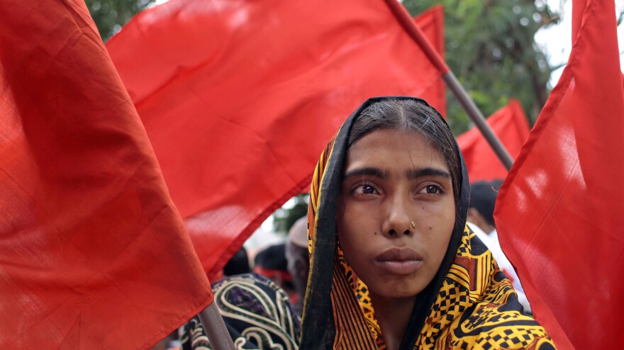 A Bangladeshi garment worker participates in a protest outside the Bangladesh Garment Manufacturers and Export Association office building in the capital, Dhaka, on July 11. The country's Parliament approved a new law that would allow workers to unionize more freely.