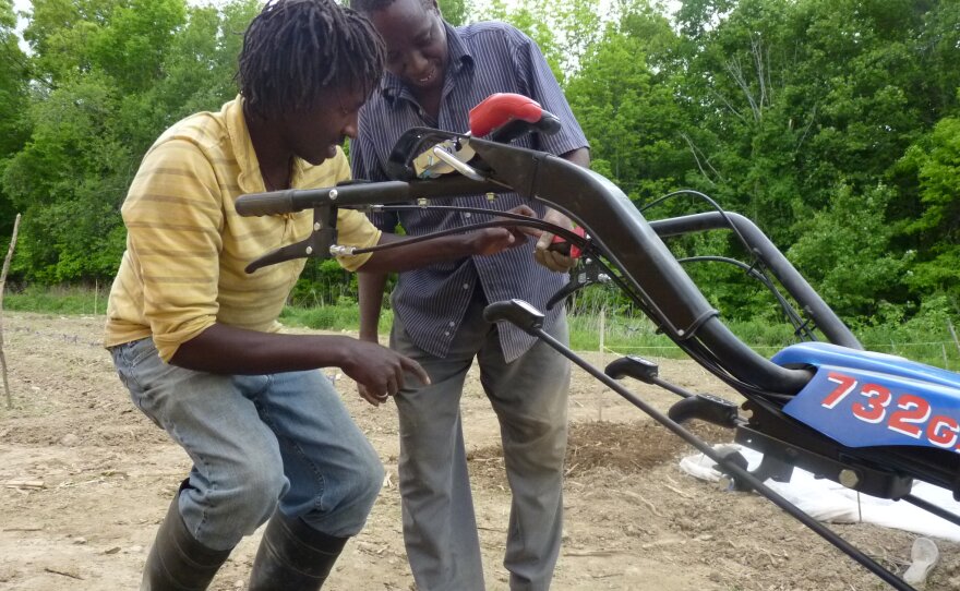 Munene training farmers on the rototiller