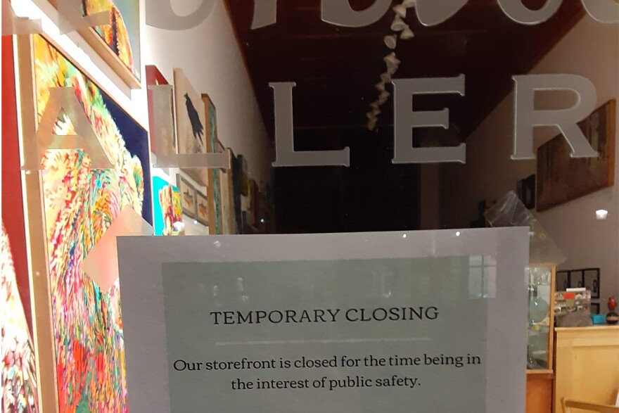 A temporarily closed sign is posted in an art gallery in Bozeman, Montana, March 18, 2020.