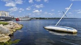 An abandoned sailboat is partially submerged in the Indian River near Cocoa Village Marina, in Cocoa Beach, on Tuesday, June 30, 2020. 