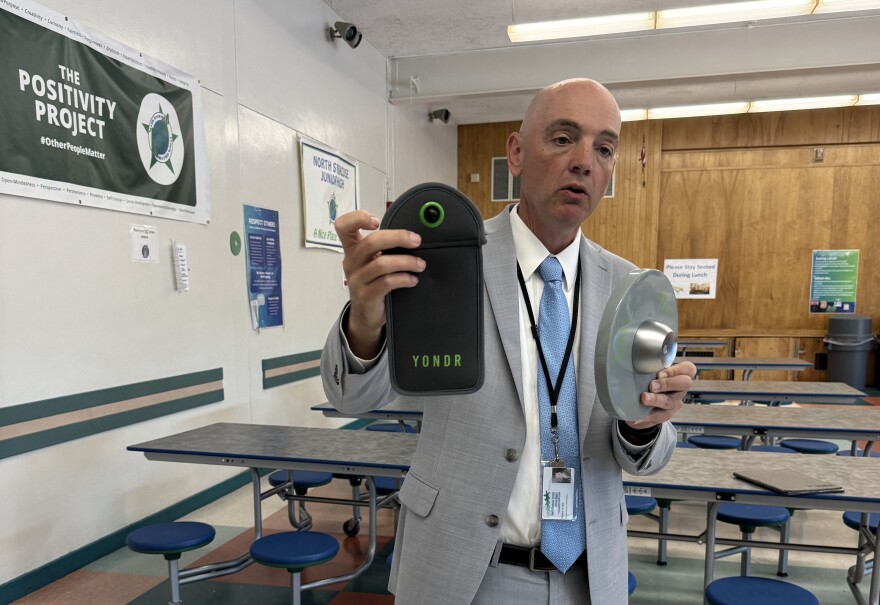 North Syracuse School District Superintendent Terry Ward shows one of the YONDR pouches that students will use to keep their cell phones in during the school day.