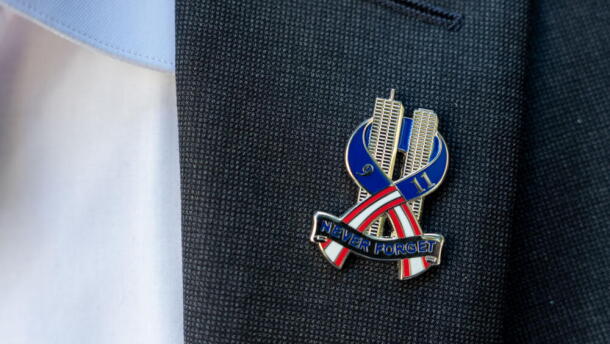 Brett Eagleson, 40, President of 9/11 Justice, wears a 9/11 pinduring a press conference demanding accountability regarding the Kingdom of Saudi Arabia's role in the 9/11 terrorist attacks, Tuesday, Sept. 8, 2026, in New York. (Adam Gray/AP)