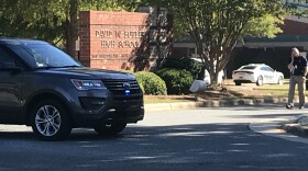 Police cars are stationed outside of Butler High School after the October 2018 shooting.