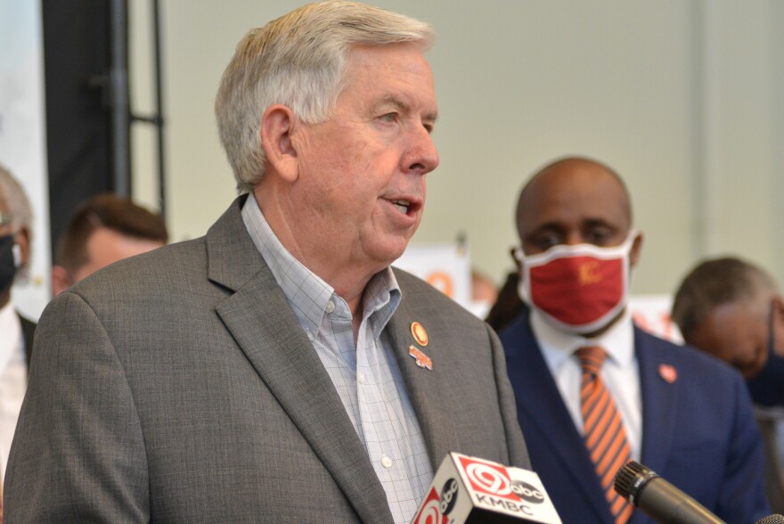 Kansas City Mayor Quinton Lucas listens to Gov. Bill Parsons during a visit earlier this year.