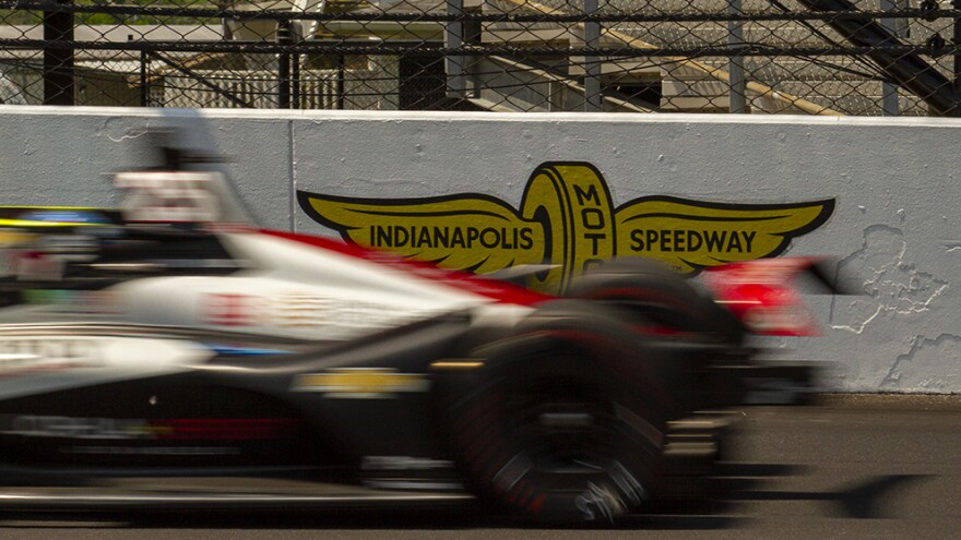 Stefan Wilson speeds past an Indianapolis Motor Speedway logo during practice for the Indianapolis 500 on Friday, May 20.