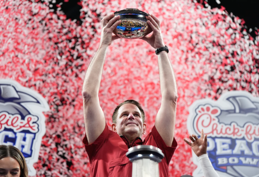 Indiana head coach Curt Cignetti holds up the trophy after the Peach Bowl NCAA college football playoff semifinal against Oregon, Friday, Jan. 9, 2026, in Atlanta.