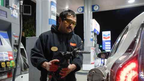 An attendant prepares to fill a customers tank at a gas station on Wednesday, May 6, 2026, in Portland, Ore. (AP Photo/Jenny Kane)