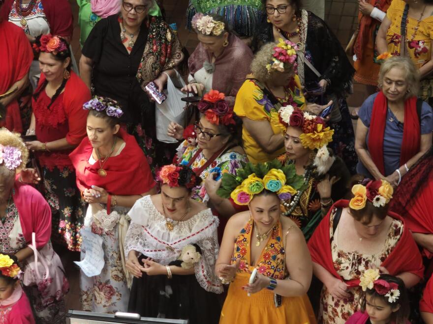 An array of Friday look-alikes line up by the stage before a promenade across the stage for happy fans and family.