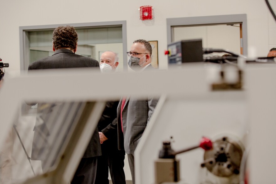 Secretary of Education Miguel Cardona listens to Mark Hill, CEO of Eastern Connecticut Workforce Investment Board, at the Ella T. Grasso Technical High SchoolÕs Manufacturing Center. During the visit, Secretary Cardona spoke about his willingness to expand career and technical education across the nation.