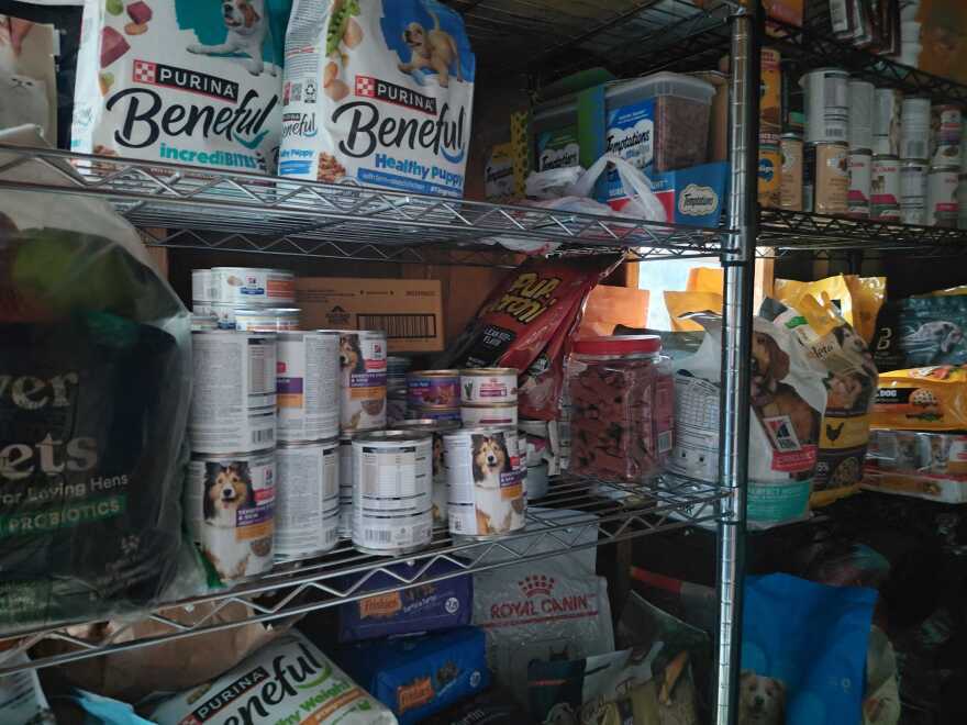 Shelves of cat and dog food are in a shed at the Dallas Humane Society. 
