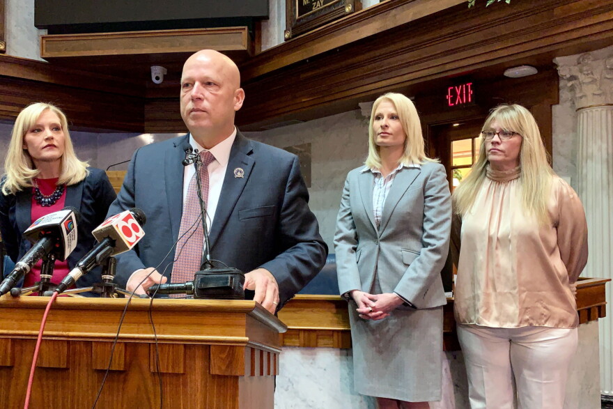 Sen. Mike Crider (R-Greenfield) talks about his legislation with Sen. Erin Houchin (R-Salem), left, and sexual assault prevention advocates supporting him.