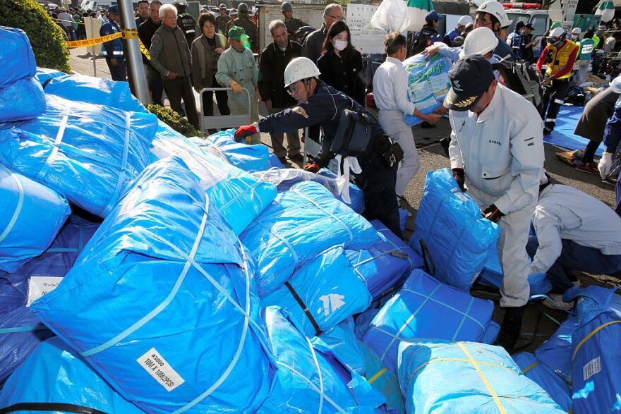 Vinyl sheets are distributed in case of rain at an evacuation center in Mashiki, Kumamoto, Japan on Saturday.