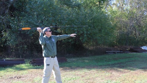 Steve Govero, assistant outdoor education center manager at Andy Dalton Shooting Range and Outdoor Education Center, demonstrates how to use the atlatl (photo taken November 4, 2025).