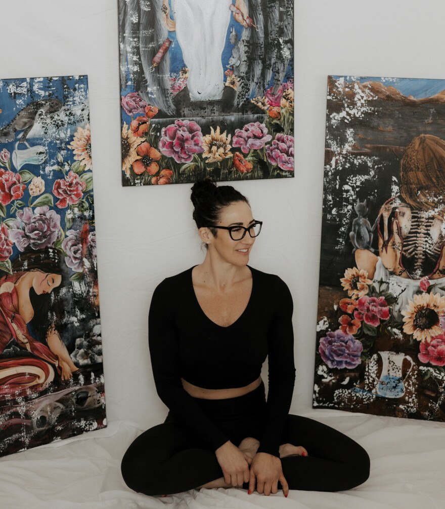 Gallerist/artist Stephanie Stone, surrounded by her paintings.