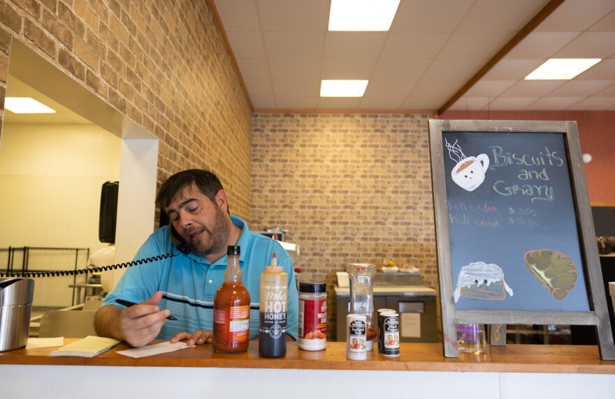 Rise manager Robert Edwards sits at the Rise cafe, which closed in October because of low sales; it later reopened as a deli, which costs less to run.