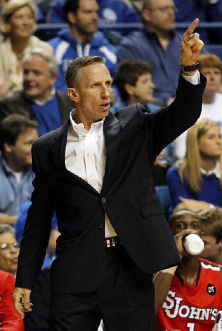 St. John's interim head coach Mike Dunlap directs his team during the first half of an NCAA college basketball game won 81-59 by