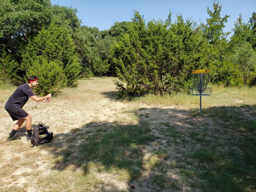 Emanuel Martinez prepares a putt at Northwest Vista's disk golf course.