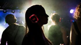 A woman wearing headphones dances in a disco during the Clockenflap Music Festival in Hong Kong, China last year.