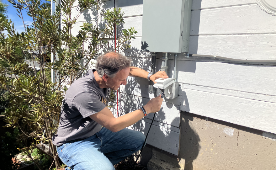 Rupert Mayer plugs his solar panels into a dedicated outlet at his Berkeley home.
