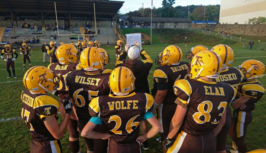 A Titusville football coach draws up a play before the homecoming match. The Rockets lost the game 36-13 to nearby Cochranton en route to going winless on the season.